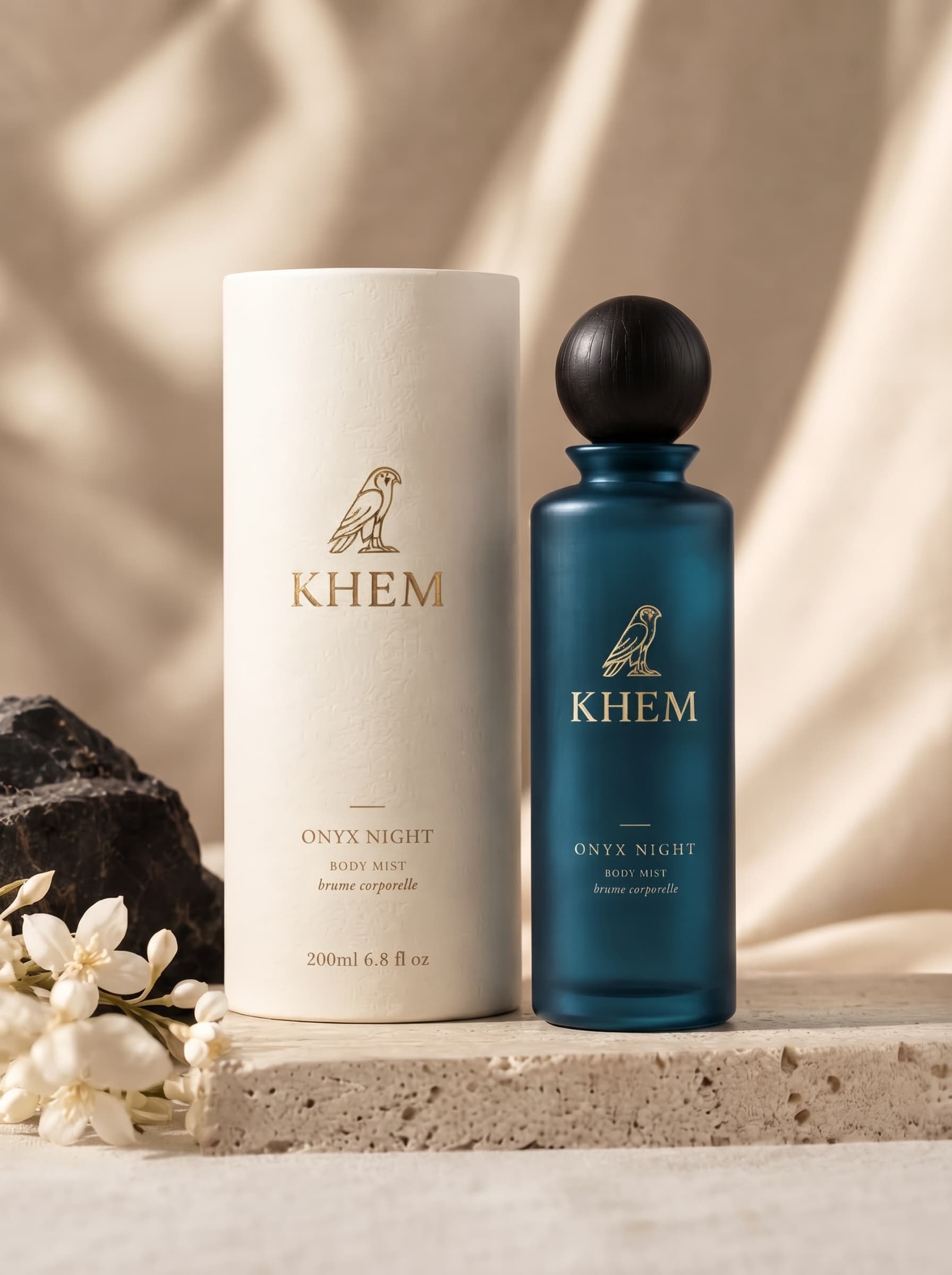 The ONYX NIGHT body mist bottle standing in soft golden light